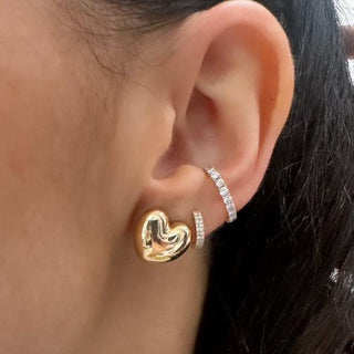 About: These heart stud earrings are crafted in 14K gold with a softly rounded, sculptural shape. Playful in silhouette and polished in finish, they offer a more modern take on a classic motif.

Metal: 14K Yellow Gold&nbsp;

Length: 0.5"

Width: 0.5"


Closure:&nbsp;Push back