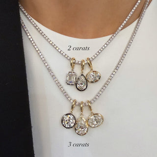 About: This oval pendant features a softly rounded silhouette set in 14K gold for a clean, balanced look. Simple yet elevated, it adds a refined statement to any chain.

Diamond Details: Lab Grown Diamond

Total Carat Weight: 2 or 3 Carats
Color: E/F
Clarity: VS

Metal:&nbsp;14K Solid Gold

Available in&nbsp;14K Yellow Gold, 14K White Gold, Two-tone (14K White Gold Front + 14K Yellow Gold Back + Bail), Two-tone (Black Rhodium Front + 14K Yellow Gold Back + Bail)

Dimensions:

2 Carat: 8.90 mm Long x 11.8 mm