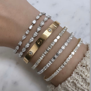 About: A continuous row of emerald cut stones gives this tennis bracelet a clean, linear look. Set in 14K gold, it feels sleek, refined, and quietly striking.

Diamond Details:&nbsp;Approx 45 Emerald Cut Natural Diamonds

Total Carat Weight:&nbsp;6.82 Carats
Color:&nbsp;G/H
Clarity:&nbsp;VS1
Metal: 14K Solid Gold
Available in 14K Yellow Gold, and 14K White Gold
Length: Available in 6.5" or 7"

&nbsp;

Closure:&nbsp;Push clasp with safety latch