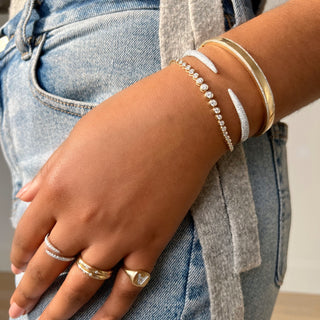 About: This pavé cuff bracelet features a sleek open silhouette with tapered ends lined in round diamonds. Crafted in 14K gold, it feels sculptural, polished, and quietly statement making.

Diamond Details: 340 Pavé Natural Diamonds

Total Carat Weight: 0.82 Carats
Color: G/H
Clarity: SI

Metal: 14K Solid Gold&nbsp;

Lengths: Available in 15, 16, 17, 18, and 19 cm

Closure: Hinge closing&nbsp;