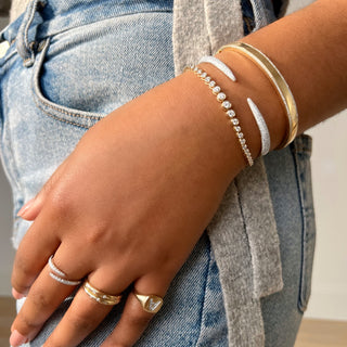 About:&nbsp;This diamond bangle pairs 14K gold with fine rows of pavé diamonds for a look that feels both subtle and distinctive. Clean, sculptural, and easy to style, it adds a refined layer to any wrist stack.

Diamond Details:&nbsp;Pavé Natural Diamonds

Total Carat Weight: 0.74 Carats
Color: G/H
Clarity: SI

Metal: 14K Solid Gold

Available in 14K Yellow Gold, and 14K White Gold

Lengths: Available in 15, 16, 17, 18, and 19 cm

Closure:&nbsp;Push clasp with safety latch&nbsp;