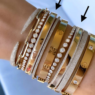 About:&nbsp;This diamond bangle pairs 14K gold with fine rows of pavé diamonds for a look that feels both subtle and distinctive. Clean, sculptural, and easy to style, it adds a refined layer to any wrist stack.

Diamond Details:&nbsp;Pavé Natural Diamonds

Total Carat Weight: 0.74 Carats
Color: G/H
Clarity: SI

Metal: 14K Solid Gold

Available in 14K Yellow Gold, and 14K White Gold

Lengths: Available in 15, 16, 17, 18, and 19 cm

Closure:&nbsp;Push clasp with safety latch&nbsp;