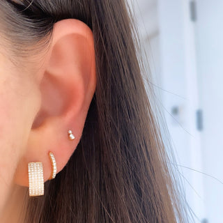 About: These huggie earrings are lined with round diamonds in 14K gold for a clean, classic look with added sparkle. Refined and easy to wear, they bring a polished touch to everyday styling.

Diamond Details: 16 Natural Diamonds

Total Carat Weight: 0.11 Carats
Color: G/H&nbsp;
Clarity:&nbsp;SI+

Metal: 14K Solid Gold

Available in 14K Yellow Gold, 14K White Gold and 14K Rose Gold

Width:&nbsp;1.75 mm

Diameter:&nbsp;12 mm

Closure:&nbsp;Latch