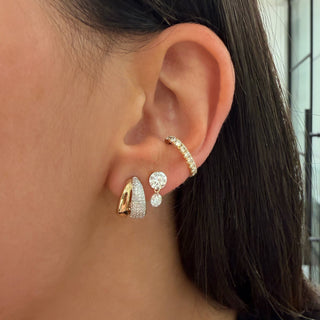 About: Polished gold and pavé diamond curves come together in a sculptural double-row silhouette. Bold yet easy to wear, these huggies bring dimension and modern sparkle to any ear stack.

Diamond Details: Pavé Natural&nbsp;Diamonds

Total Carat Weight: 0.36 Carats
Color:&nbsp;G/H
Clarity: SI

Metal: 14K Gold

Closure:&nbsp;Push Back

Sold as a pair.
