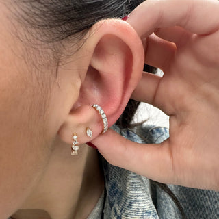 About:&nbsp;These huggie earrings feature a mix of round, pear, and baguette cut diamonds set in 14K gold for a dimensional, unique look. The varied shapes give them a distinct rhythm that feels polished but still playful.

Diamond Details: 10 Mixed Shape Diamonds

Total Carat Weight: 0.27 Carat&nbsp;
Pear diamonds: 0.11 Carats Each
Round diamonds: 0.08 Carats Each
Baguette diamonds: 0.08 Carats Each
Color: G/H&nbsp;
Clarity: SI+

Metal: 14K Solid Gold

Available in 14K Yellow Gold, and 14K White Gold

Widt