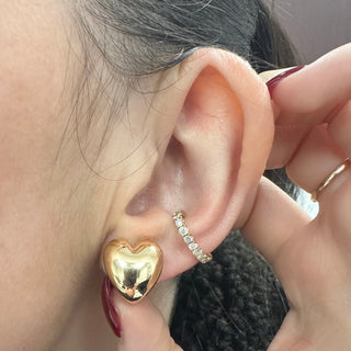 About: These heart stud earrings are crafted in 14K gold with a softly rounded, sculptural shape. Playful in silhouette and polished in finish, they offer a more modern take on a classic motif.

Metal: 14K Yellow Gold&nbsp;

Length: 0.5"

Width: 0.5"


Closure:&nbsp;Push back