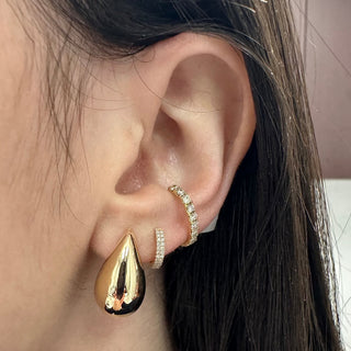 About: These pear shape stud earrings are crafted in 14K gold with a smooth, sculptural silhouette. Their softly rounded shape gives them a bold look that still feels clean and understated.

Metal: 14K Yellow Gold

Length: 20 mm

Closure: Push back