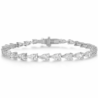 About: This pear shape tennis bracelet features a continuous row of stones set in 14K gold for a clean, fluid silhouette. Classic and easy to wear, it brings a refined finish to any stack.

Diamond Details: Pear Cut Lab Grown Diamonds

5.5 Carat Variation
Approx 36 Lab Diamonds (Each 0.15 Carats)
9 Carat Variation
Approx 26 Lab Diamonds (Each 0.35 Carats)
Color: E/F
Clarity: VS

Metal:&nbsp;14K Gold

Available in 14K Yellow Gold or 14K White Gold

Length: Available in 6.5" or 7"

Closure:&nbsp;Under Locking