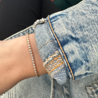 About: A fine row of bezel set stones gives this bracelet a clean, delicate line across the wrist. Crafted in 14K gold, it feels classic, polished, and easy to layer.

Diamond Details: 21 Round Natural Diamonds

Total Carat Weight:&nbsp;0.50 Carats
Color:&nbsp;G/H
Clarity:&nbsp;SI

Metal:&nbsp;14K Solid Gold

Available in 14K Yellow Gold, and 14K White Gold

Width:&nbsp;1.5 mm

Length: Adjustable 6-7"

Closure:&nbsp;Lobster clasp
