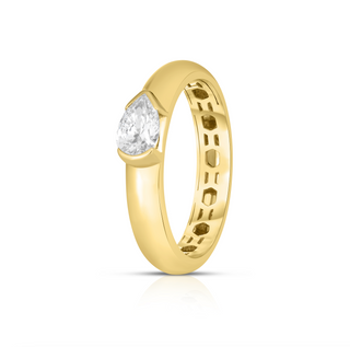 About: A modern take on a timeless silhouette, this ring features a horizontally set pear shape diamond framed in 14K yellow gold. The smooth rounded band gives it a bold yet refined feel, while the bezel-inspired setting keeps the look sleek, secure, and easy to wear every day.&nbsp;

Diamond Details: 1 Pear Shape Lab Grown Diamond

Total carat weight:&nbsp;Approx 0.50 Carats
Color:&nbsp;F
Clarity:&nbsp;VS

Metal:&nbsp;14K Gold&nbsp;

Width: 4 mm&nbsp;