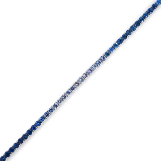 About: This blue sapphire tennis bracelet features a soft gradient of round stones in varying tones for a tonal look. Set in 14K white gold, it adds a refined pop of color to classic bracelet styling.

Stone Details:&nbsp;Natural Blue Sapphires

Total Carat Weight: Approx&nbsp;8 Carats

Metal: 14K White Gold&nbsp;


Width: Approx 3 mm

Length:&nbsp;Available in 6.5" or 7"

Closure: Box clasp with side safety&nbsp;