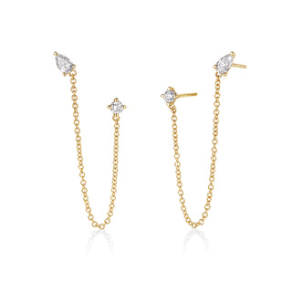 About: Pear shape and round lab diamond stud are connected by a delicate gold chain, creating effortless movement between two piercings. Modern and unexpected, this pair adds a refined edge to any ear stack.

Diamond Details: 2 Pear &amp; 2 Round Lab Diamonds

Total Carat Weight: 0.79 Carats
Color:&nbsp;E/F
Clarity: VS

Metal: 14K Gold

Chain Length: 3"

Closure:&nbsp;Push Back

Sold as a pair.